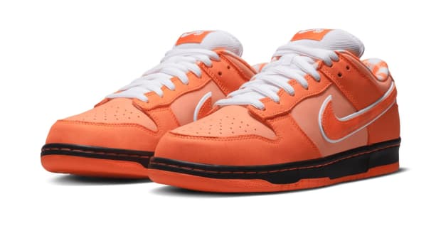 Side view of orange and white Nike Dunk sneakers.
